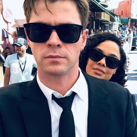 Chris Hemsworth and Tessa Thompson wearing sunglasses